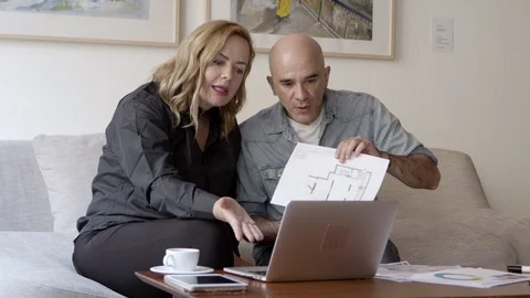 Serious couple looking at home project and choosing color palette Stock Footage 121004302