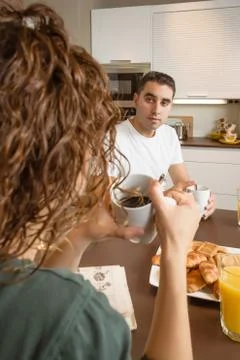 Serious couple with problems speak at breakfast Stock Photos