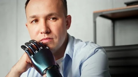 Serious cyborg disabled man with bio prothesis thinks Stock Footage 157348058
