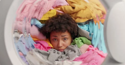 Serious discontent curly haired young Afro American woman sticks head in heapof Stock Footage 156968856