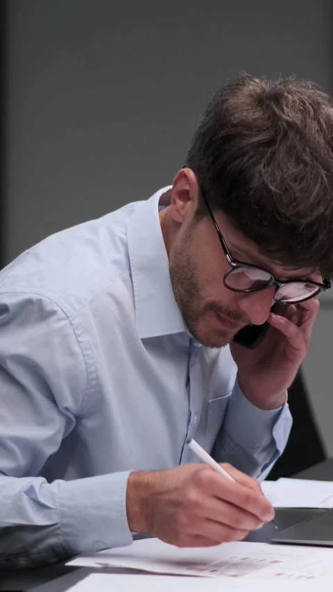 Serious Employee Working With Documents And Talking Phone In The Office Stock Footage 287320159