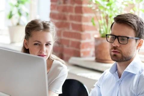 Serious employees work at computer cooperating in office 스톡 사진