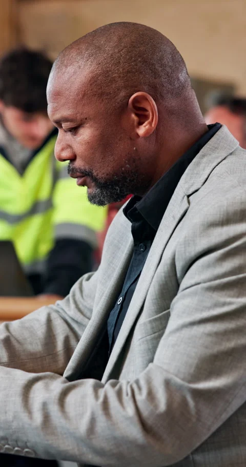 Serious, engineer and man with team in building, project management and planning Stock Footage 348192426