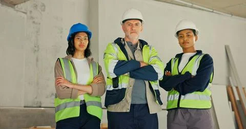 Serious, engineer and team with arms crossed in building, portrait and soli.. Stock Photos