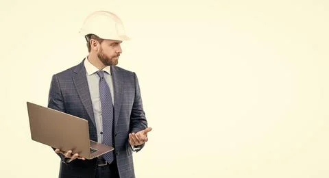 Serious engineer man in hardhat and suit use laptop computer for constructing Stock Photos