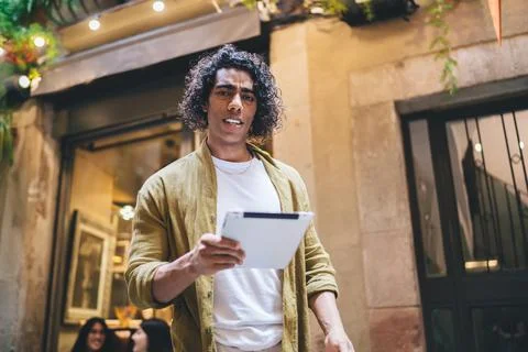 Serious ethnic man using tablet on terrace Stock Photos