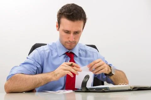 Serious executive analyzing paper document Stock Photos