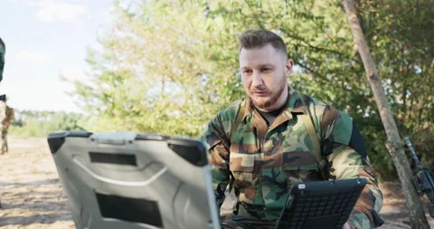 Serious experienced army commander is in field having video conversation on Stock Footage 169379871