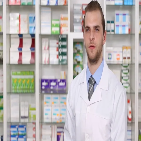 Serious Experienced Pharmacist Man Looking and Talking Camera in Pharmacy Shop Video stock 69719025