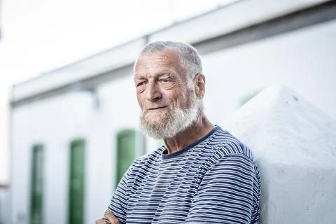 Serious expression of charming man with blue eyes. 75 year old elderly man .. Stock-Fotos