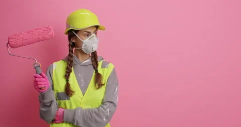 Serious female construction worker dressed in uniform protective helmet and Stock-Footage 156226631