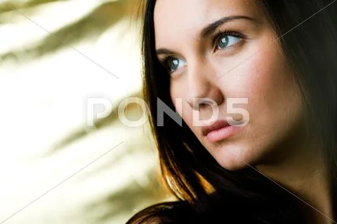 Serious female with green eyes looking aside Stock Photos