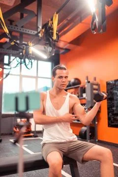 Serious fit man having a tutorial online Fotos Stock