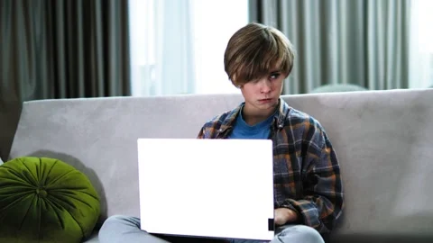 Serious focused boy using pc laptop, little future programmer using computer Stock Footage 228431963