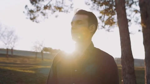 The serious, focused man looks to one side, isolated in a rural meadow Stock Footage 153219085