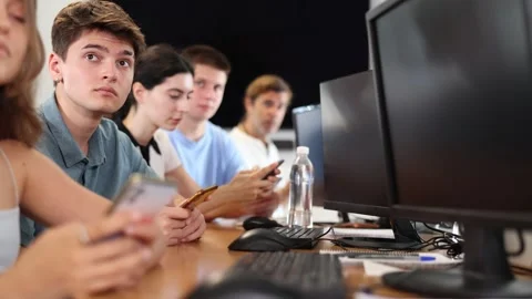 Serious focused young student studying together with coursemates in computer Stock Footage 260675001