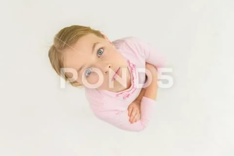 The serious girl look to the camera. View from above Stock Photos