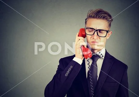 Serious grumpy offended business man having unpleasant phone call conversatio Stock Photos