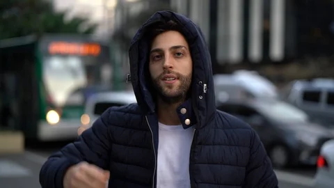 Serious Guy Looking at Camera in city background Stock Footage 89728936