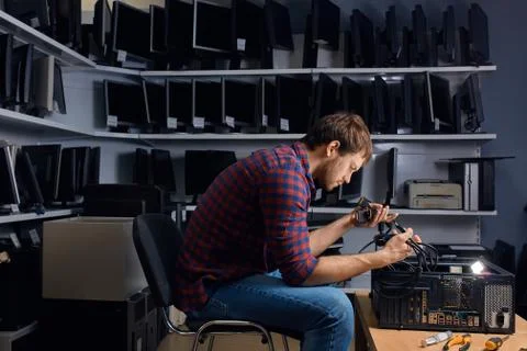 Serious guy trying to looking for a missing wire Stock Photos