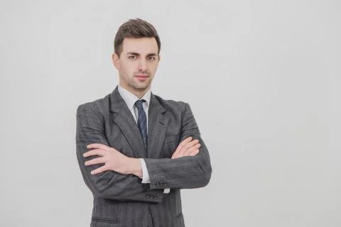 Serious handsome businessman standing with his hands folded, looking confidently Stock Photos