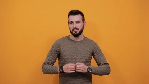 Serious handsome caucasian man doing shape of heart, looking pretty, smiling Video stock 121439980