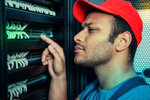 Serious handsome man checking work of the server Stock Photos