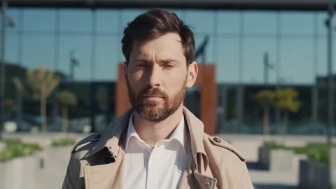 Serious handsome man looking at camera stand on street. Cheerful man face with Stock Footage 200231381