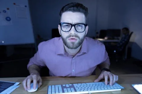 Serious hard working programmer looking at the screen Stock Photos