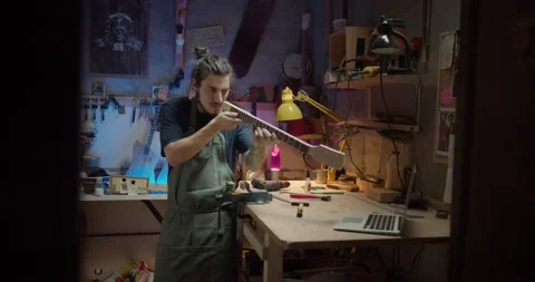 Serious Hispanic foreman lutemaker at joinery workshop making handicraft musical Stock Footage 137242405