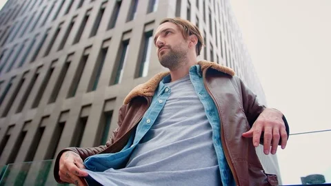 Serious Hispanic man gets out-of-pocket mobile phone to check business Stock Footage 115910243
