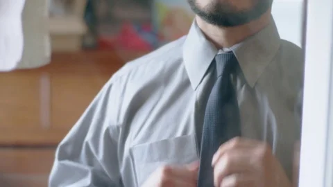 Serious hispanic man getting ready in the mirror Stock Footage 84481618