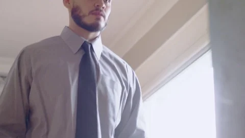 Serious hispanic man practicing handshake in front of mirror Stock Footage 84487549