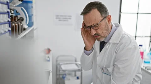 Serious hispanic scientist at lab, suffering headache while working, a mid-.. Stock Footage 262204001