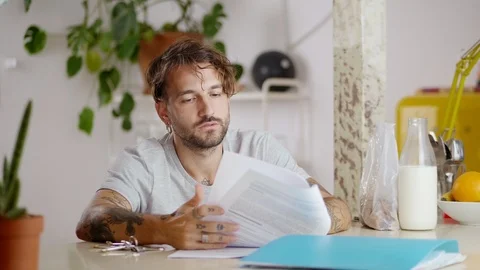 Serious Hispanic young man thoughtful dealing with domestic communal paper bill Stock Footage 108796164