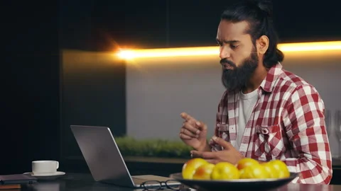 Serious Indian freelancer having online video call with employer on his laptop Stock Footage 316836335