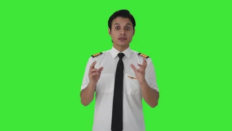 Serious Indian male pilot talking Green screen Stock Footage 253159853