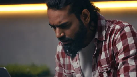 Serious Indian male programmer facing problems with code on laptop, software bug Stock Footage 316836311