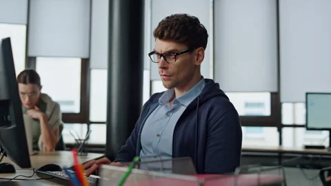 Serious it guy typing computer in office. Professional programmer code using two Stock Footage 242982308