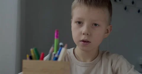 Serious kid child doing homework picture indoors slow motion. Close up front Stock Footage 146937871