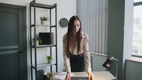 Serious lady puts the laptop on the table and smiling Video stock 225449567