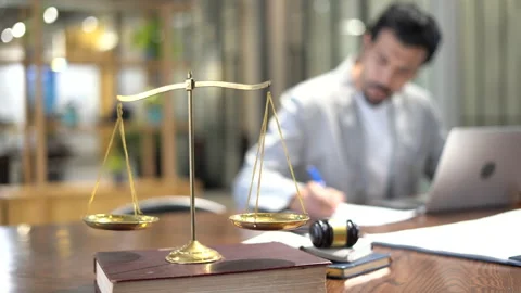Serious lawyer working with laptop computer and take note take note of lawsui Stock Footage 168665312