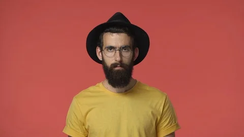 Serious-looking jewish, middle-eastern handsome bearded man in black hat, round Stock Footage 115777912