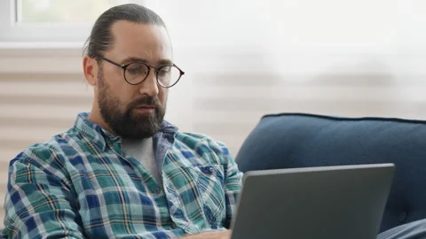 Serious male programmer typing on laptop at home, working remotely, freelancer 스톡 동영상 237451413