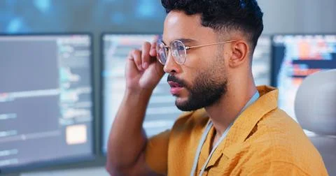 Serious, man and computer coding with programming tech for cybersecurity Foto stock