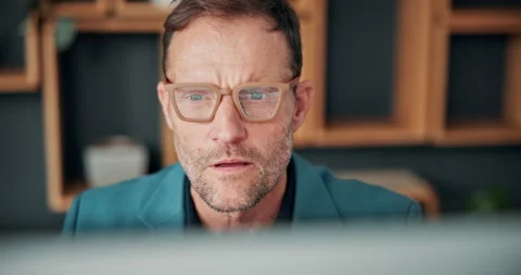 Serious, man and reading on computer in office for market timing, trading Stock Footage 341577751