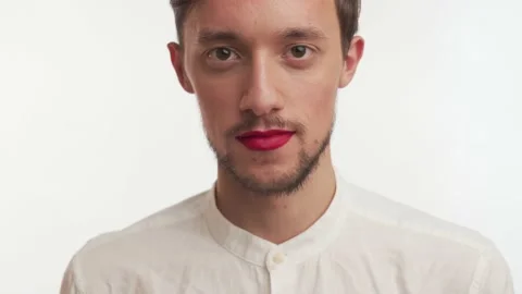 Serious man with beard, painted lips by red lipstick stare camera, smile, laugh Video stock 147574548