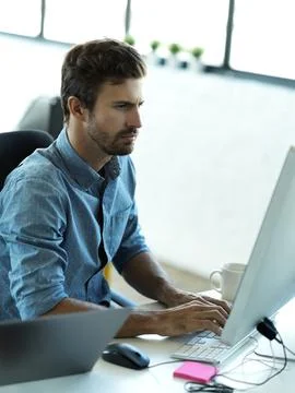 Serious man, computer typing and web business planning a website layout in Stock Photos