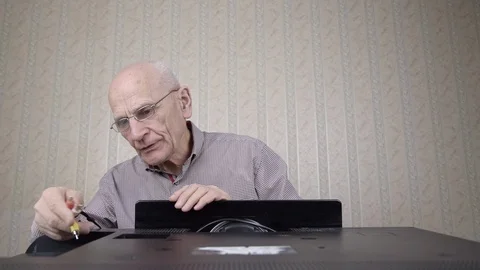 Serious man connects jacks to outdated television set panel Stock Footage 127152150