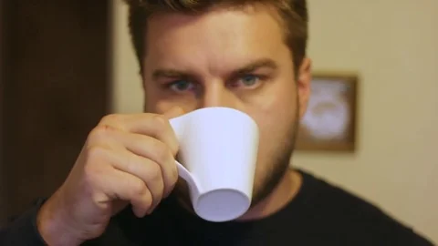 A serious man drinking coffee at home, closeup Stock-Footage 83129209